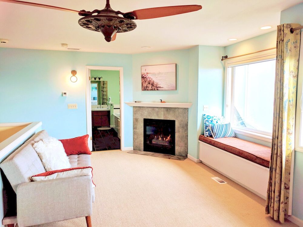 Primary bedroom with view and fireplace